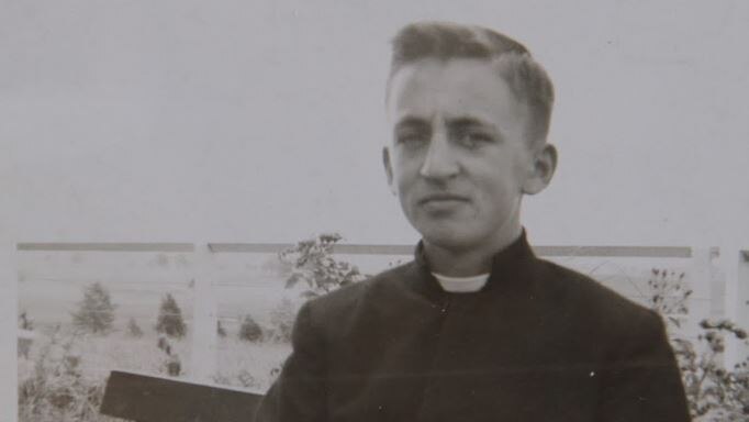 A teenage boy wearing the black habit characteristic of the Christian Brothers order.