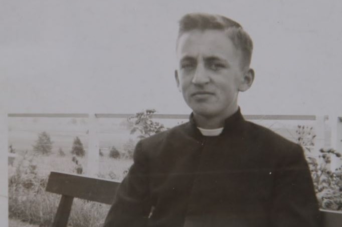 A teenage boy wearing the black habit characteristic of the Christian Brothers order.