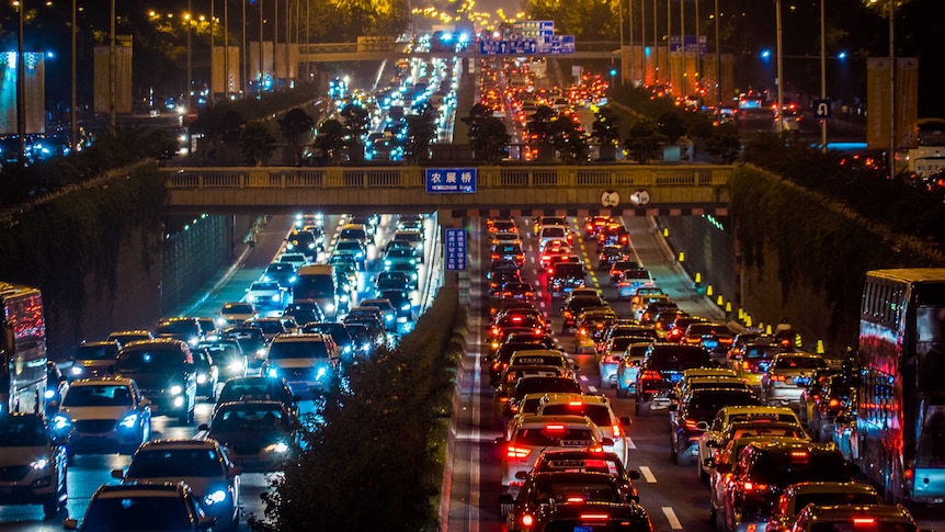 Cars fill several lanes of traffic on a Beijing road.