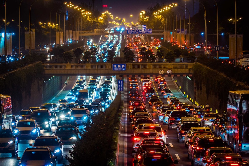 Cars fill several lanes of traffic on a Beijing road.