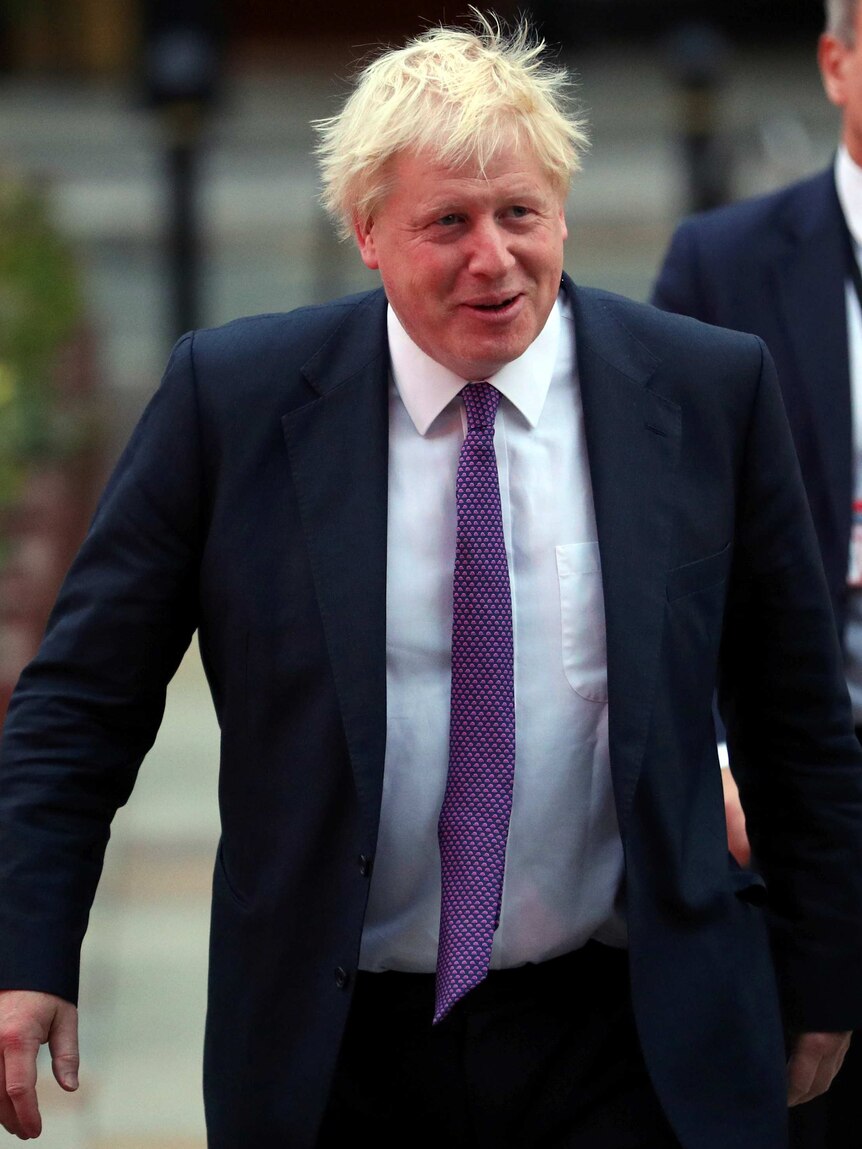 Boris Johnson walks to the main hall on the final day of the Conservative Party Conference.