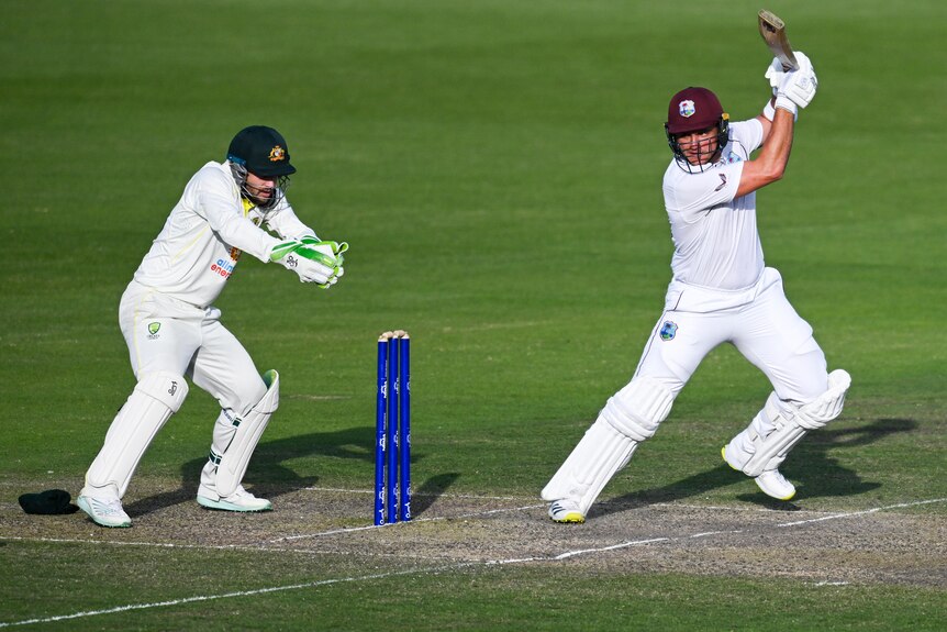A West Indies male matter plays a stroke against Prime Minister's XI.