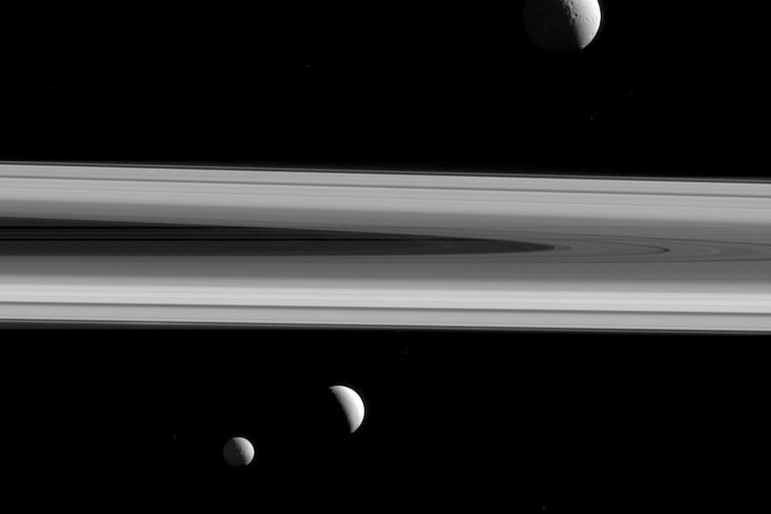 A black and white picture of Saturn's three moons.