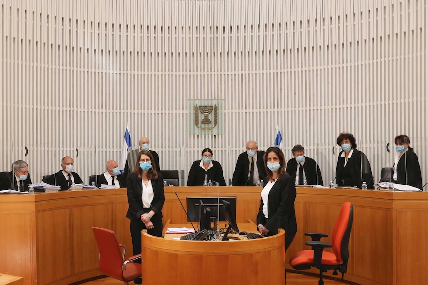 Panel of 11 Israeli Supreme Court judges wear masks in court.