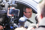 A media scrum surrounds Mark McGowan's car