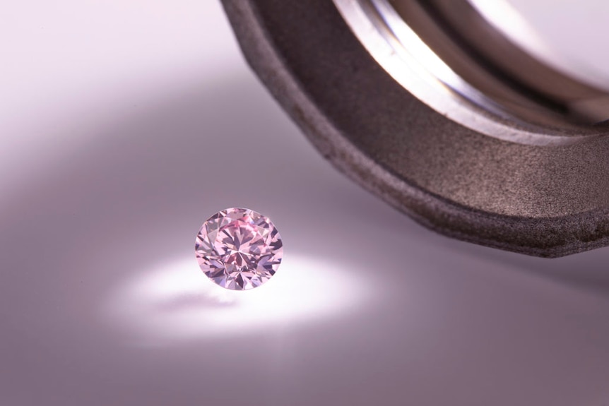 A pink diamond catches the light.