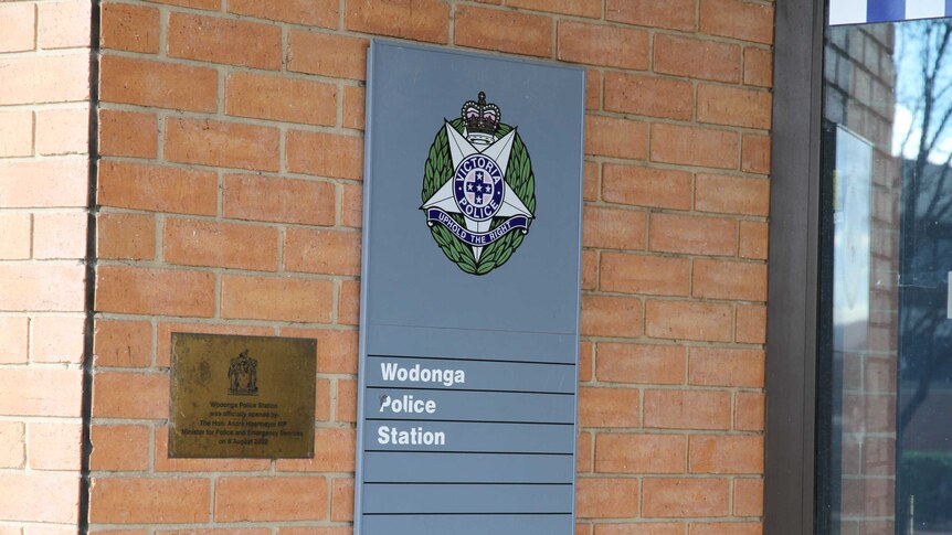 A plaque outside of a police station