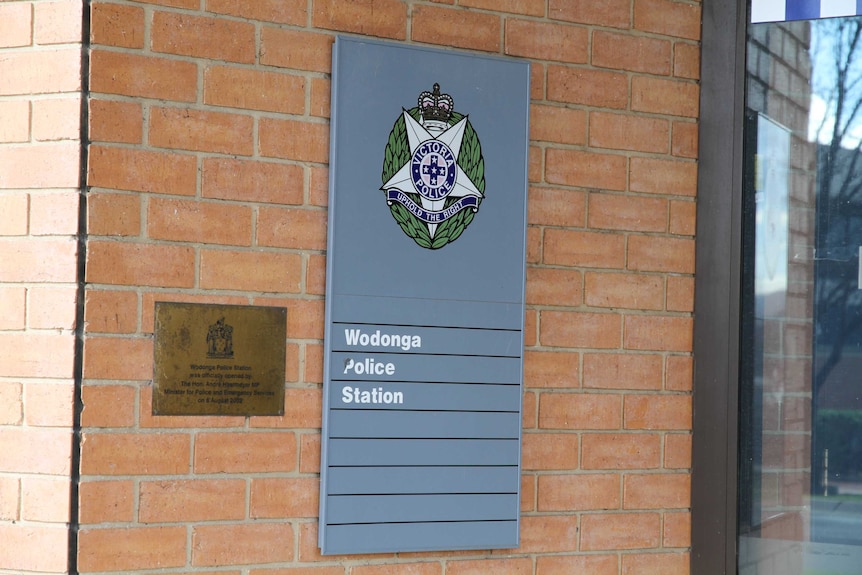 A plaque outside of a police station