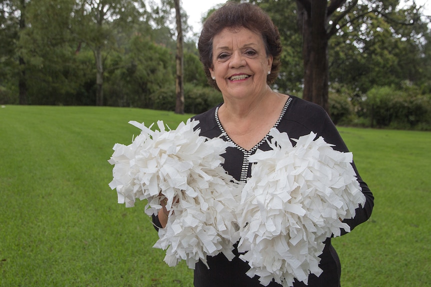 A woman holds pompoms