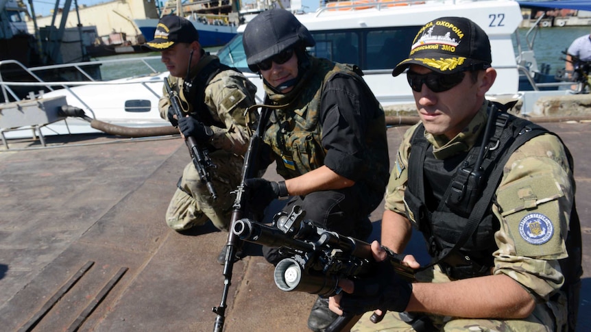 Ukrainian soldiers at a dock on the Azov Sea