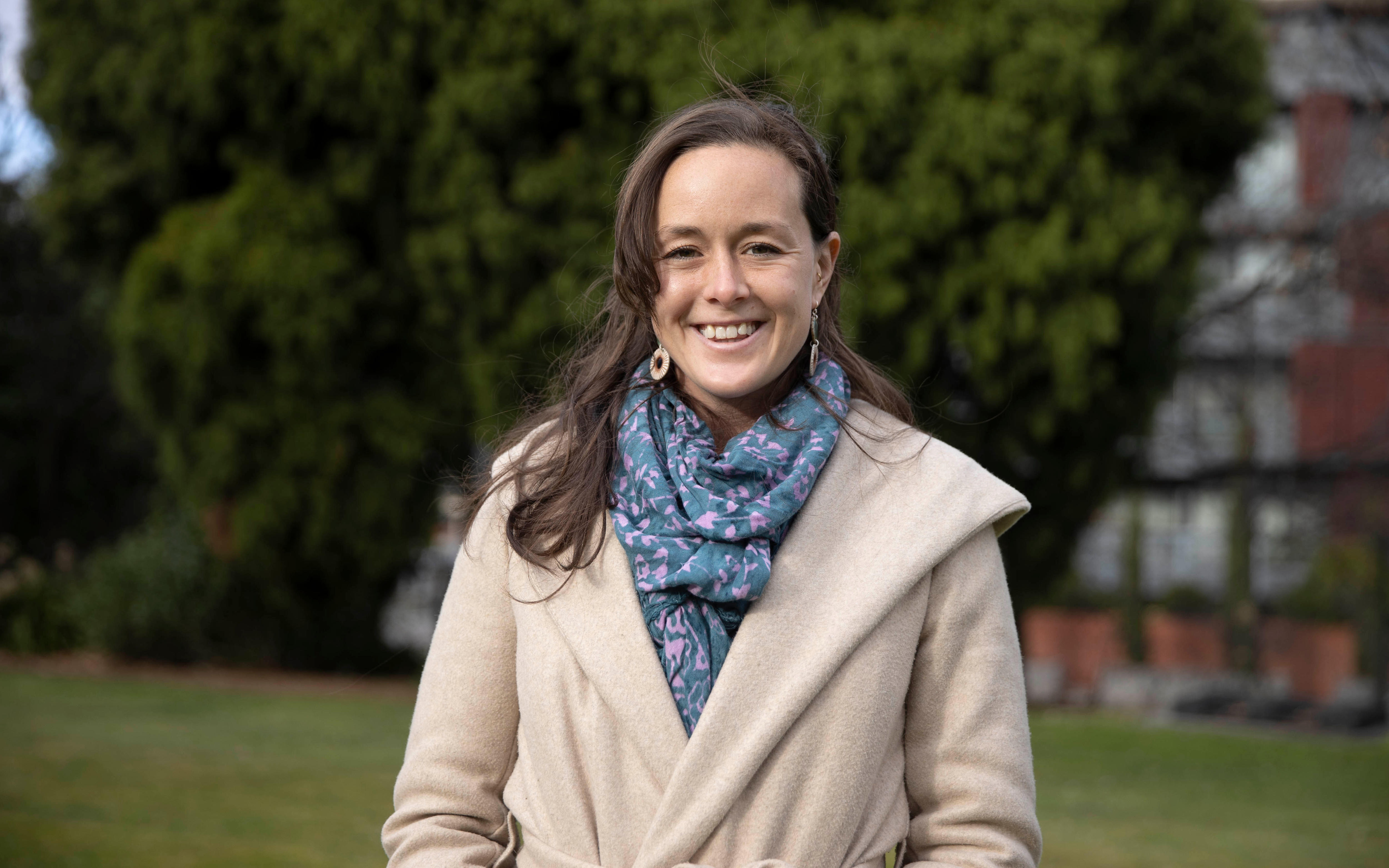 Woman wearing a coat looking forward.