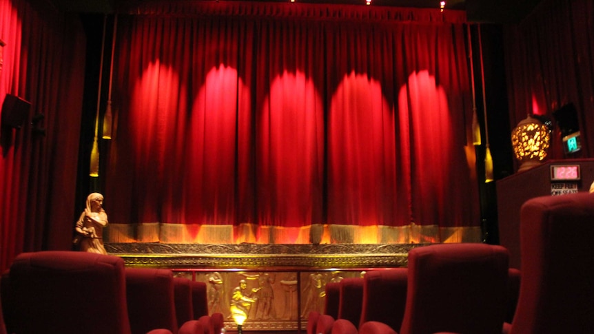 Cinema seats and bright red curtain over screen at Plaza Theatre, Laurieton.