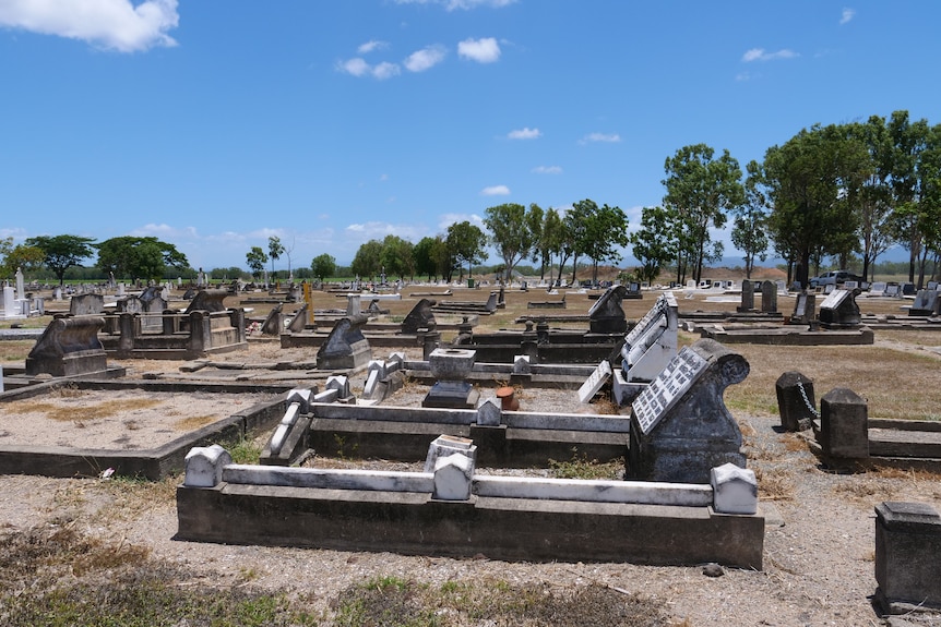 Rundown 19th century graves in full sun at a cemetery.