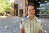 Image of a woman wearing a khaki rspca uniform outside a courthouse.