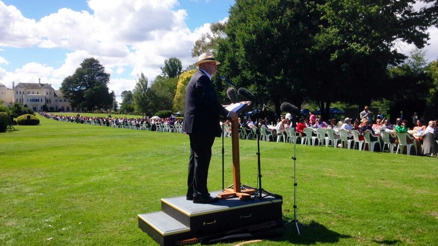 The Governor-General, Sir Peter Cosgrove, addresses the table stretching across the lawns of Government House.