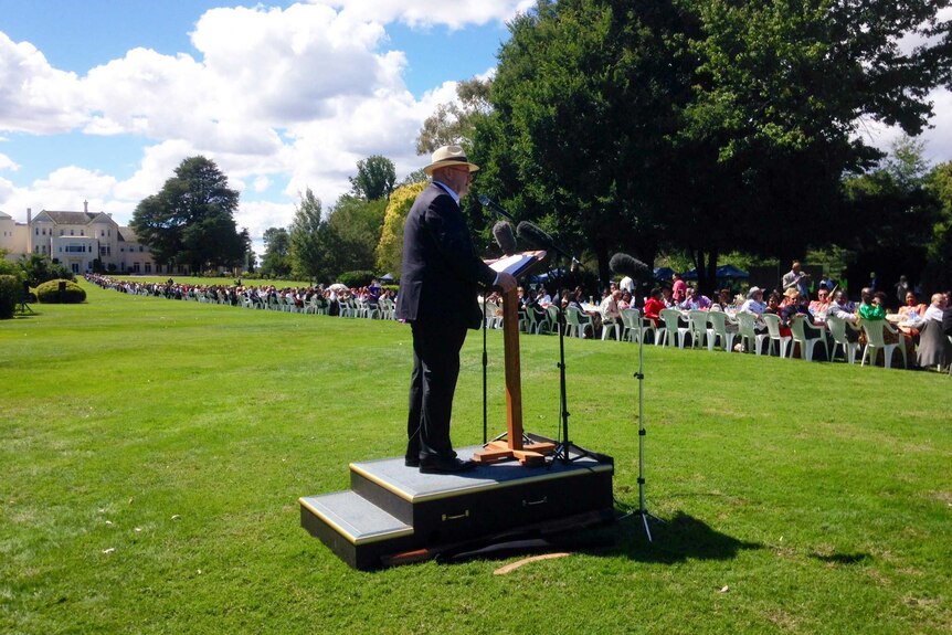 The Governor-General, Sir Peter Cosgrove, addresses the table stretching across the lawns of Government House.