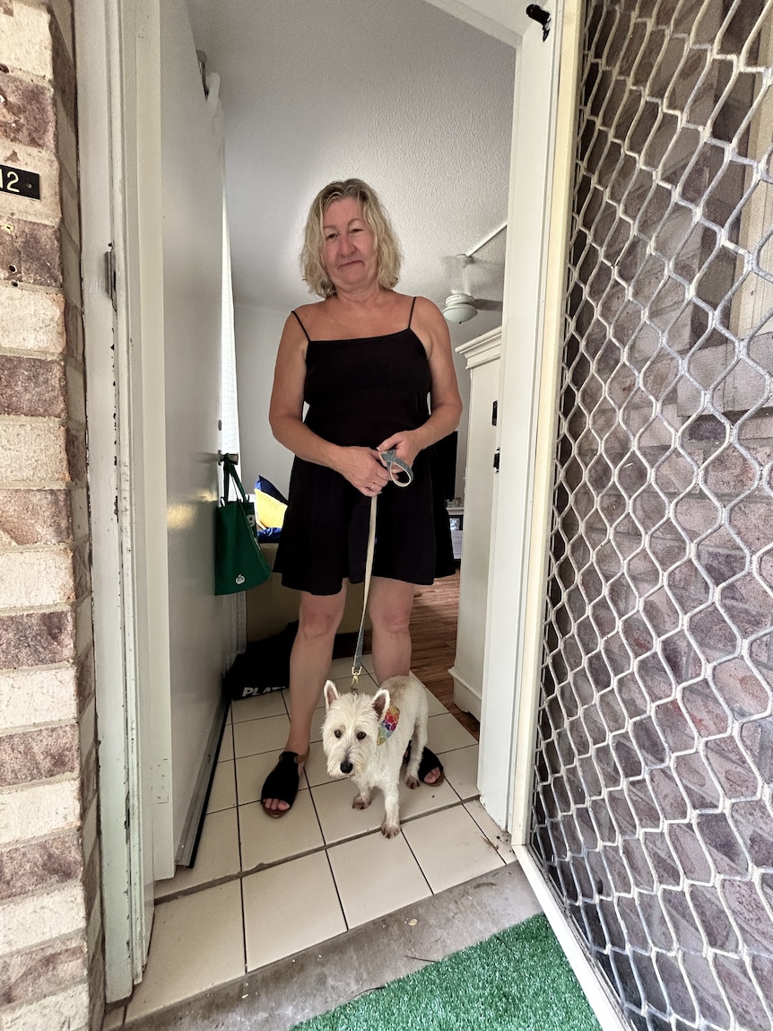 Woman in black singlet with white dog