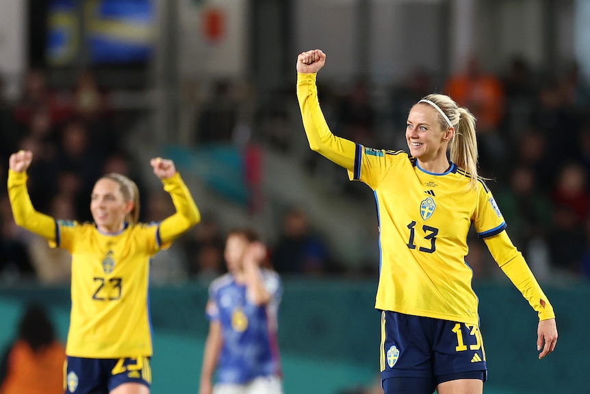 Amanda Ilestedt raises a fist as a teammate celebrates behind her during a Women's World Cup match between Sweden and Japan.