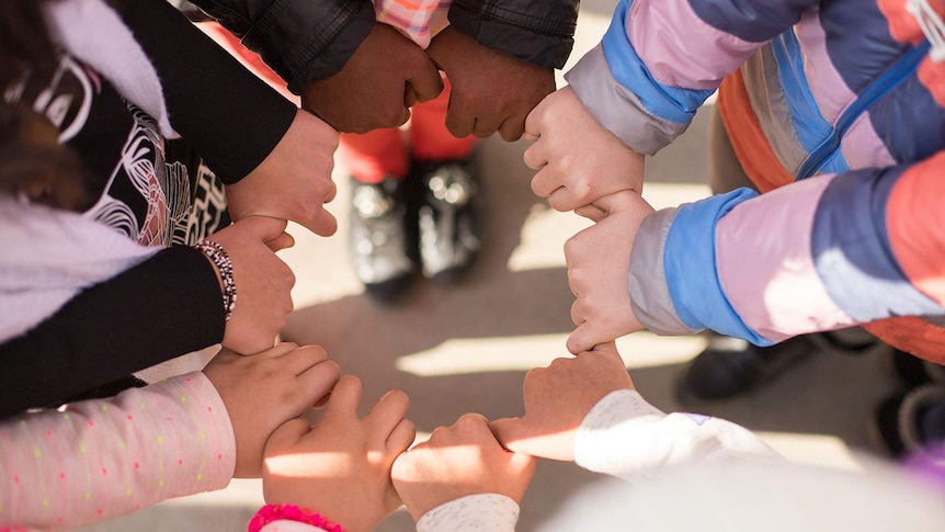 Kids holding hands in a circle