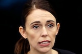 A close shot of a woman's head as she speaks at a press conference
