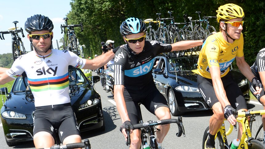 (LtoR) Mark Cavendish, Christopher Froome, and British Bradley Wiggins, ride together in the last stage of the Tour De France.