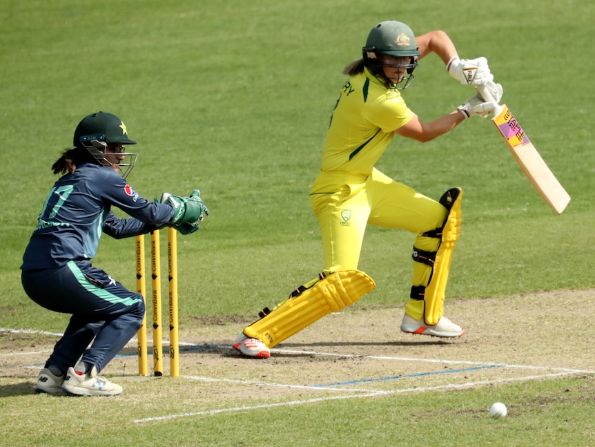 Australia's Ellyse Perry guides a ball behind square on the off-side as the Pakistan wicketkeeper watches.