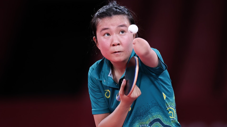 An Australian table tennis player looks at the ball in the air as she prepares to serve at the Tokyo Paralympics.  