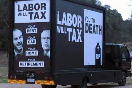 A truck with 'labour will tax you to death' written on the sides.