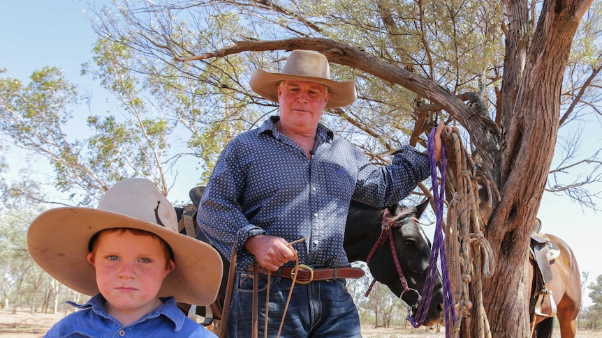 Bill Prow and his son Mason standing on their property in south-west Queensland