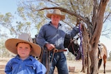 Bill Prow and his son Mason standing on their property in south-west Queensland