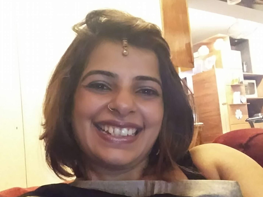 Shweta Kawatra takes a selfie while smiling at the camera. 