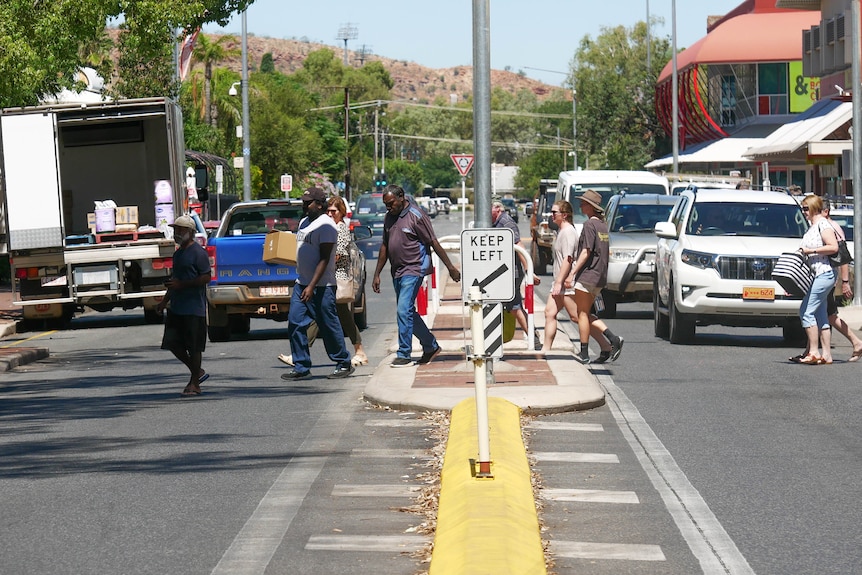 Pedestrians and cars on busy street in CBD.