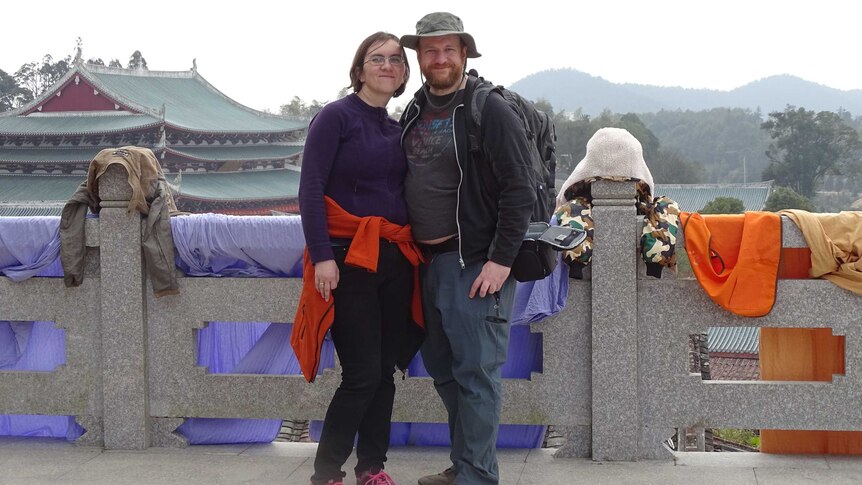 A couple taken photo in a landmark in China