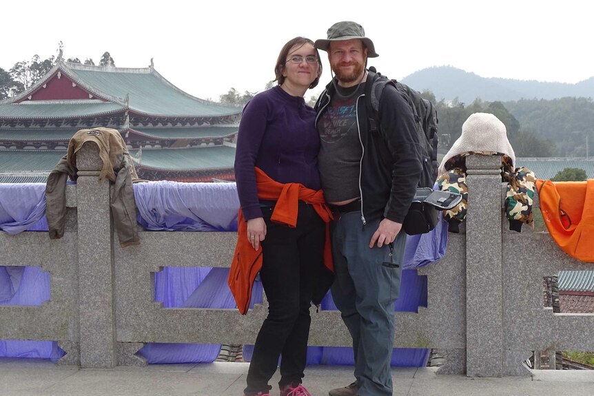 A couple taken photo in a landmark in China
