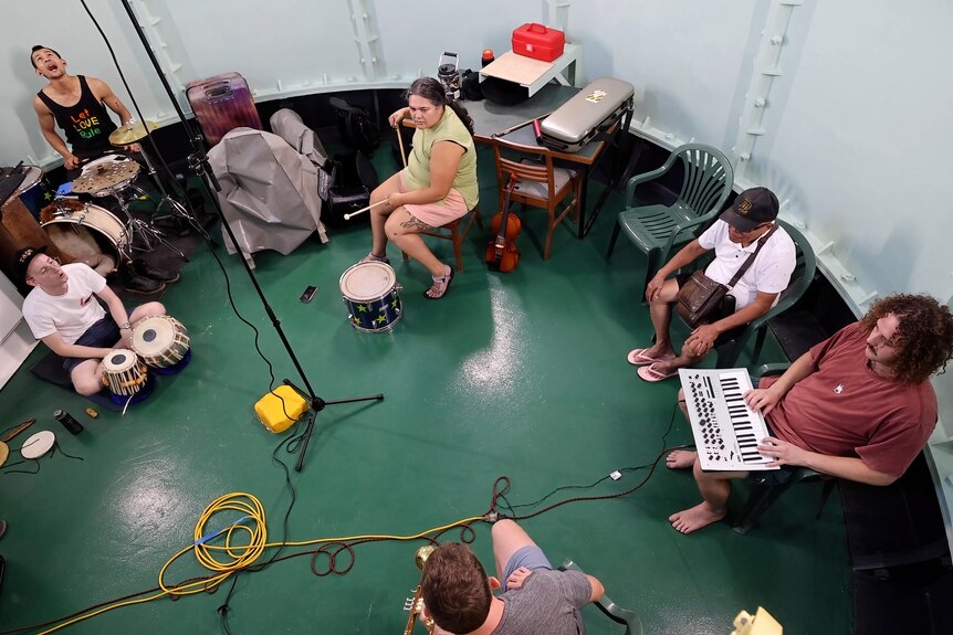 A group of musicians playing inside the bottom of the lighthouse.