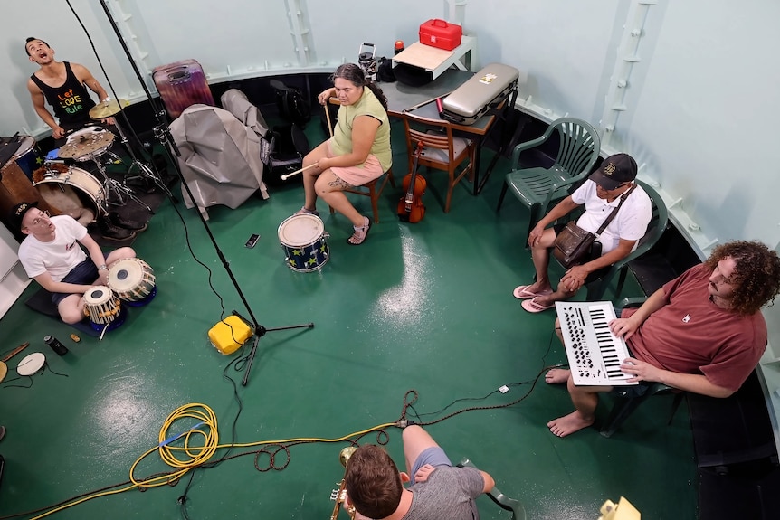 A group of musicians playing inside the bottom of the lighthouse.