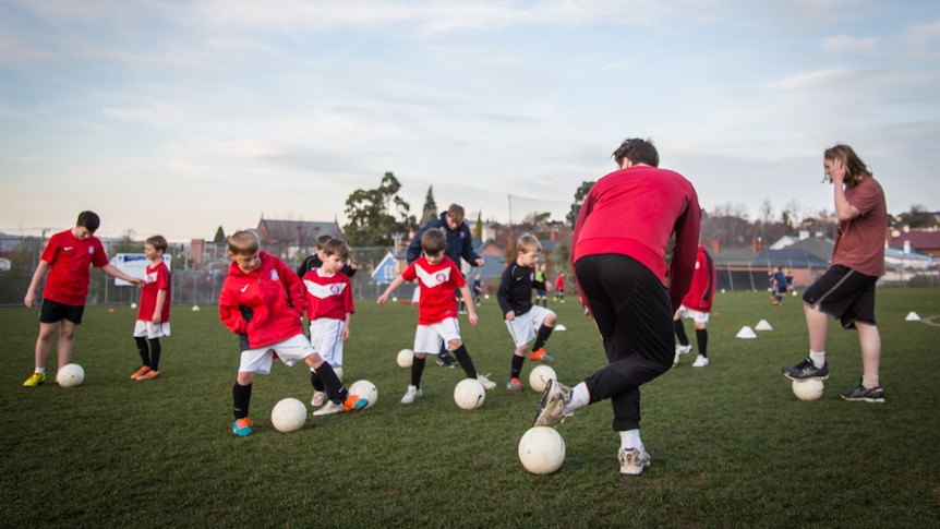 Hugo Bladel (front) offers tips to the children of the turn and twist.