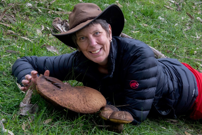 Ecologist and photographer Alison Pouliot with a giant mushroom.