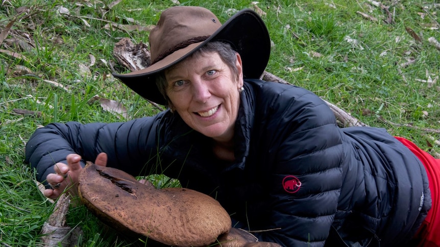 Ecologist and photographer Alison Pouliot with a giant mushroom.