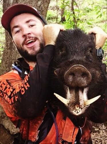 A photo from Jack O'Connor's Instagram account of him holding a dead boar.
