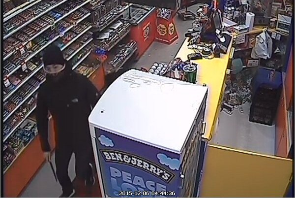 A man of Asian appearance aged between 20 and 25-years-old, dressed in black and armed with a knife inside a convenience store.