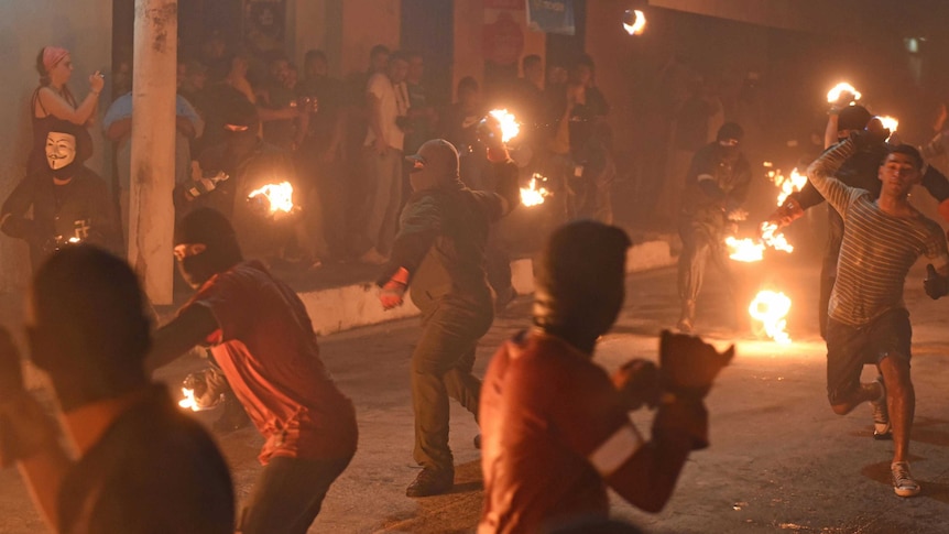 Salvadorans hurl fireballs at each other during a festival in honour of a 1922 volcanic eruption.