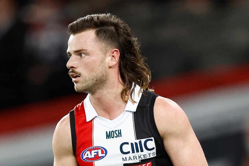 Jack Sinclair's hair is a fade on the sides, neatly styled on the top and long trailing mullet in the back