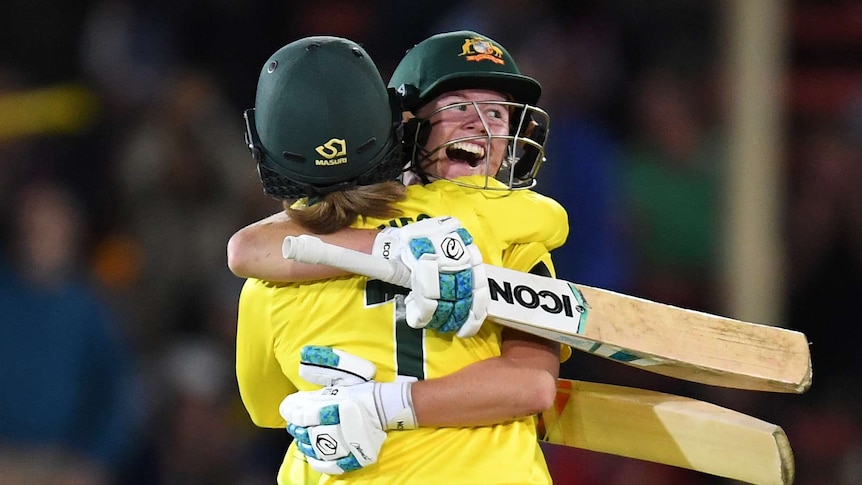 Australian batters embrace on the field after winning the Ashes