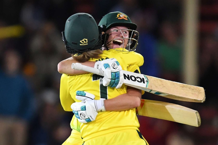 Australian batters embrace on the field after winning the Ashes
