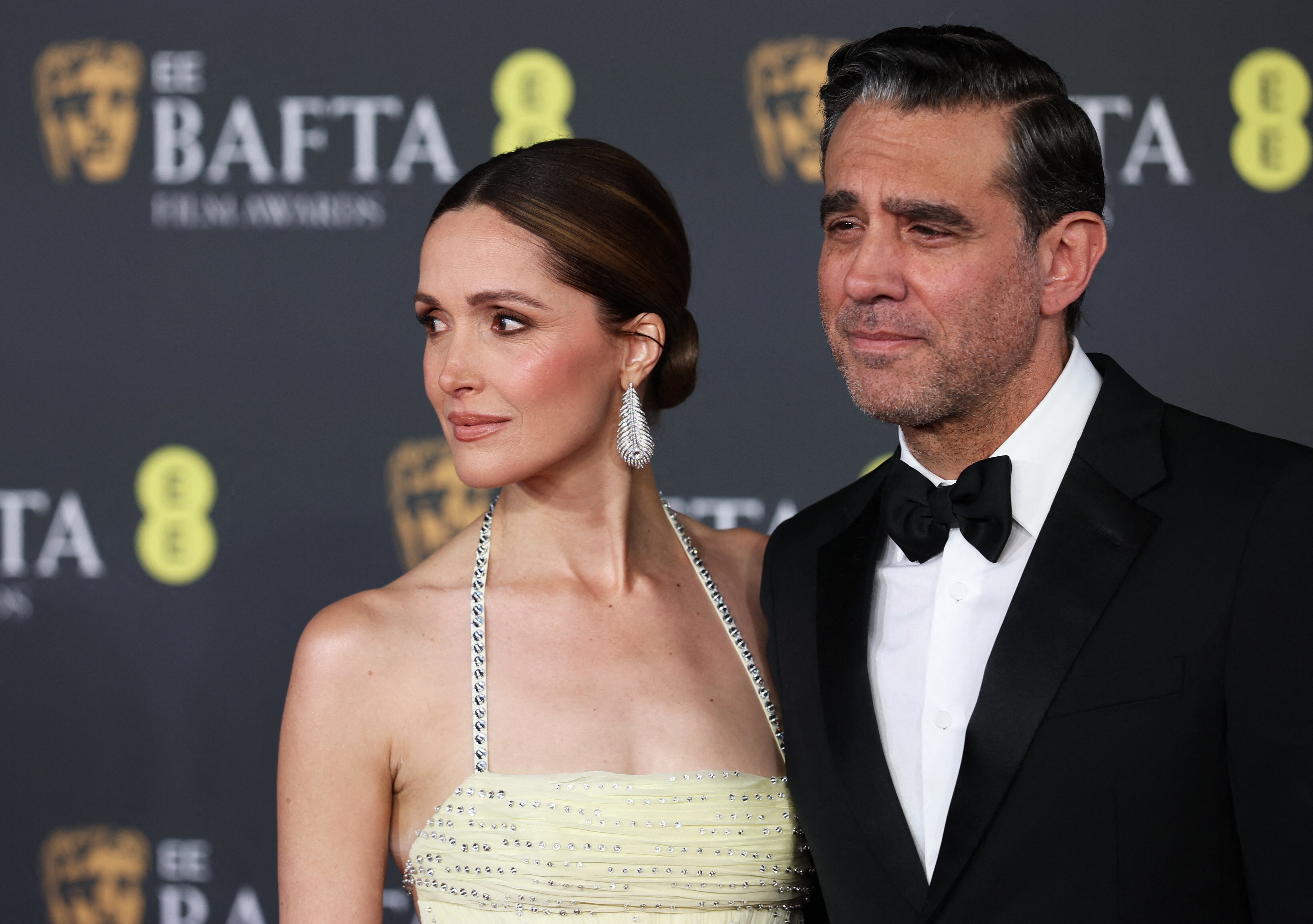 Close up of Rose Byrne in yellow gown with Bobby Cannavale