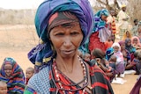 Starving and desperate: refugees and children wait to go to a refugee camp in Ethiopia