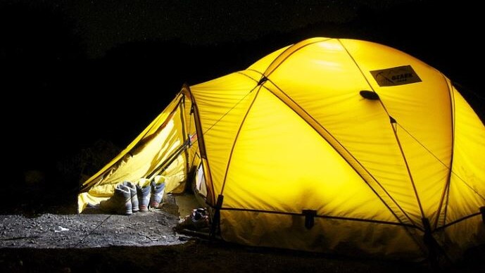 Photo of yellow tent against a night sky 