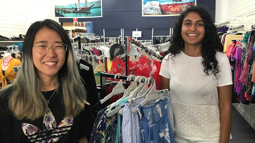 Two young girls in a clothing store