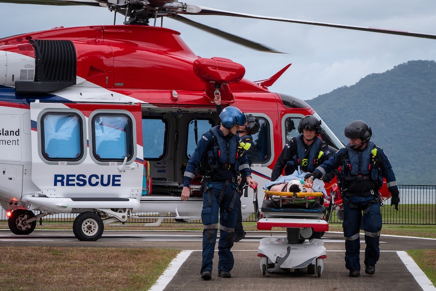 Paramedics transporting injured teen from rescue helicopter
